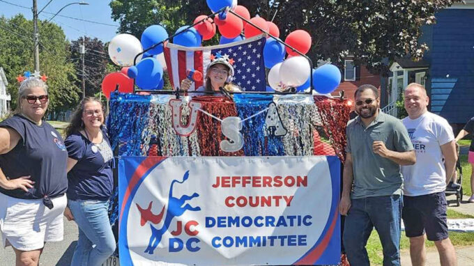 Cropped version of a color photo of Democratic candidates standing with a float in the Carthage parade in 2026