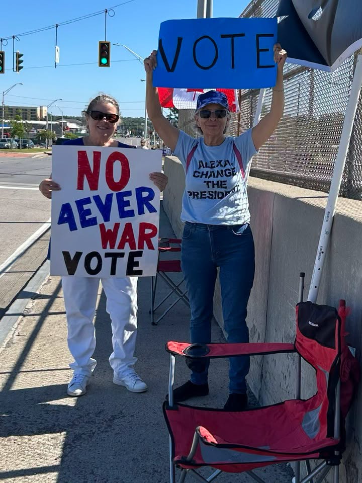 Color photo of two JCDC members participating in the Stronger Together Rally and NYS Bridge Banner Project on Sept 12, 2026 in Watertown
